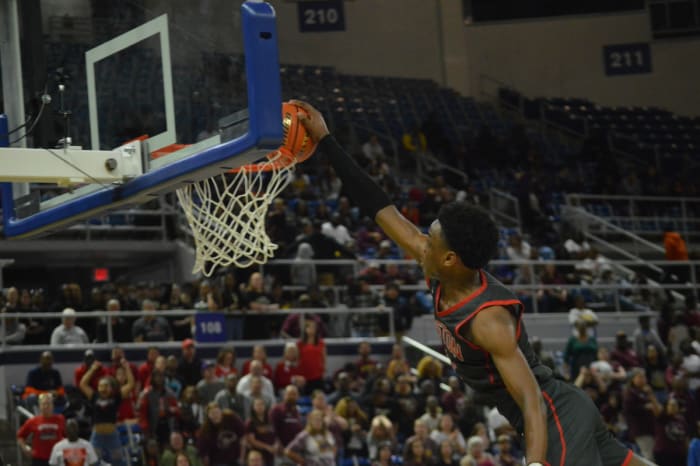Ruston freshman Ahmad Hudson (11) throws down a dunk against Natchitoches Central in the Division I non-select semifinals March 7, 2024.